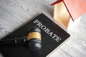 Toy house, gavel and text PROBATE
